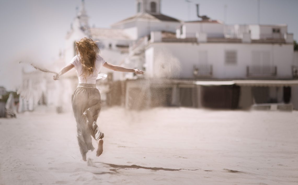 RadioMarocCulture Woman Running On Sand Near White Concrete Building 736505